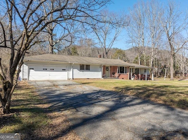 ranch-style home featuring a garage and a front lawn