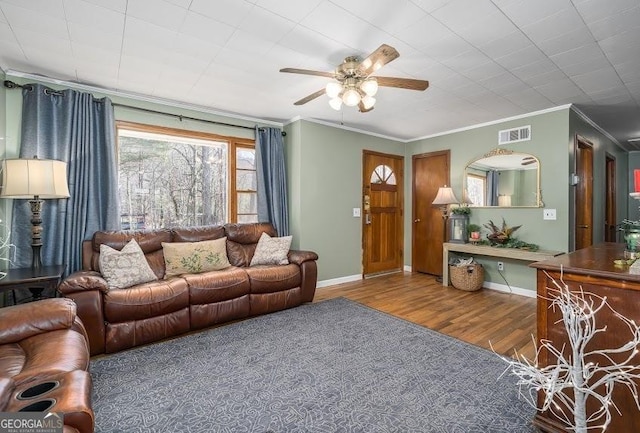 living room featuring hardwood / wood-style floors, ceiling fan, and ornamental molding