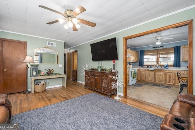 living room with light hardwood / wood-style floors and ornamental molding