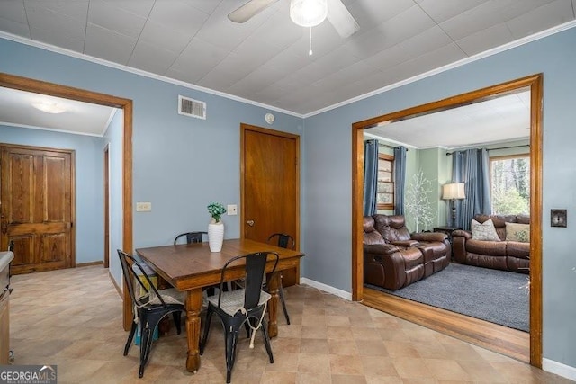 dining room with ceiling fan and ornamental molding