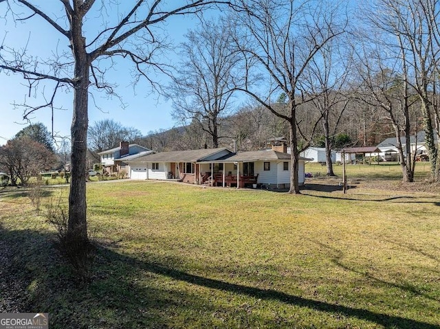 view of yard featuring covered porch