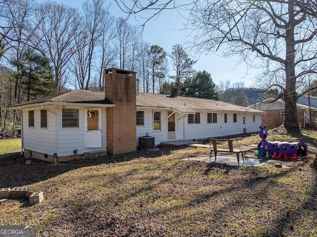 rear view of property featuring central AC unit