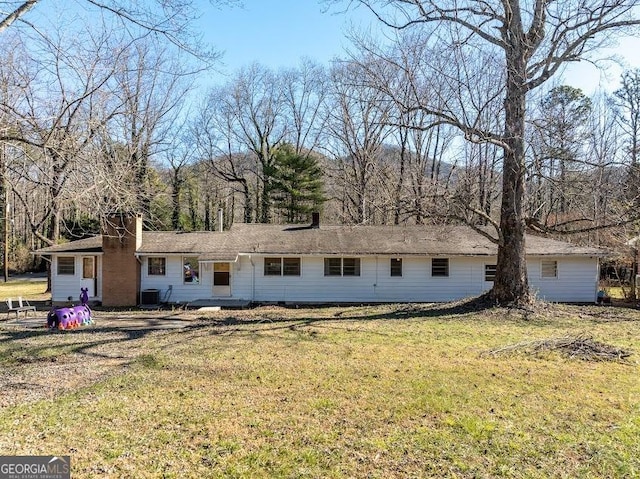 ranch-style home featuring central AC and a front yard