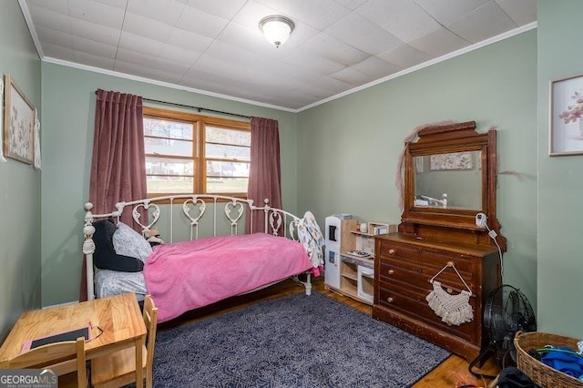 bedroom with ornamental molding and hardwood / wood-style flooring