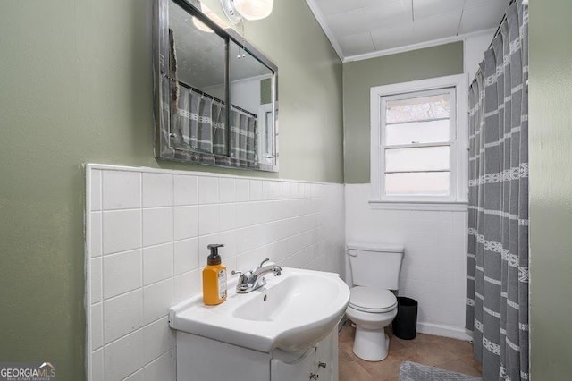 bathroom featuring tile patterned floors, toilet, vanity, and ornamental molding