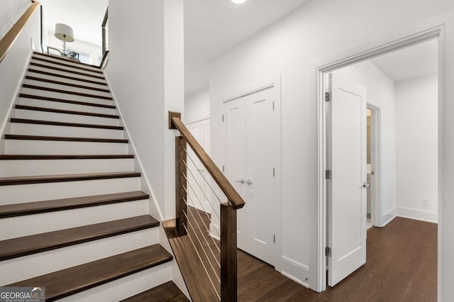 stairs featuring hardwood / wood-style flooring