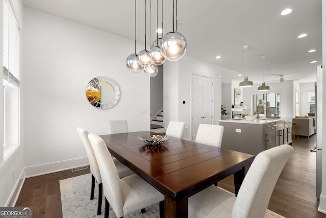 dining room featuring wood-type flooring, a wealth of natural light, and sink