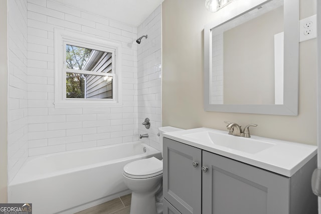 full bathroom with vanity, toilet, and tiled shower / bath combo