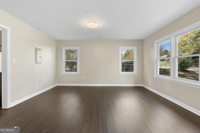 empty room with dark hardwood / wood-style flooring