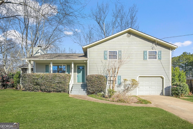 tri-level home with a front yard and a garage