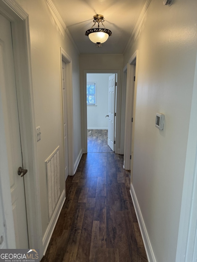 hall featuring dark wood-type flooring and crown molding