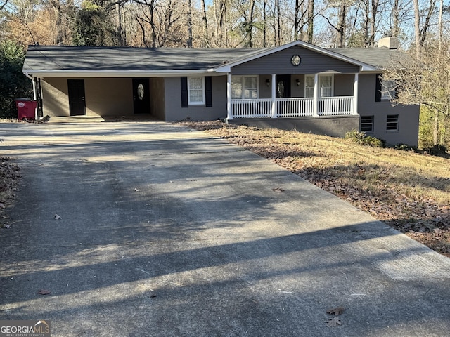 single story home with a porch and a carport