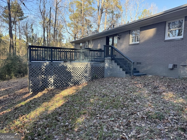 view of property exterior featuring a wooden deck