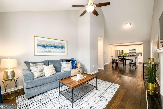 living room featuring hardwood / wood-style flooring, high vaulted ceiling, and ceiling fan