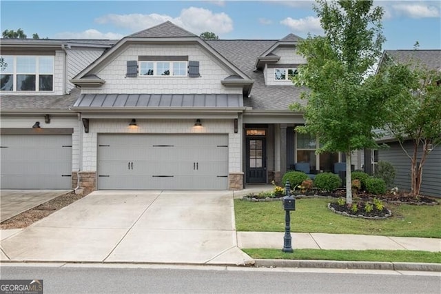 view of front of property with a front yard and a garage