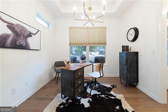 office area featuring hardwood / wood-style floors, a raised ceiling, plenty of natural light, and a notable chandelier