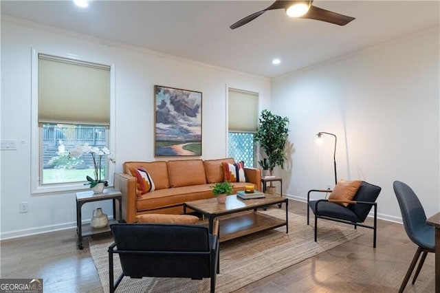 living room featuring wood-type flooring, plenty of natural light, and ornamental molding