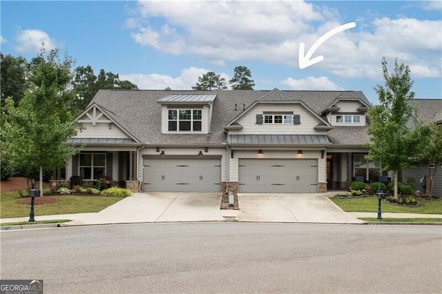 craftsman-style house featuring a garage and a front lawn