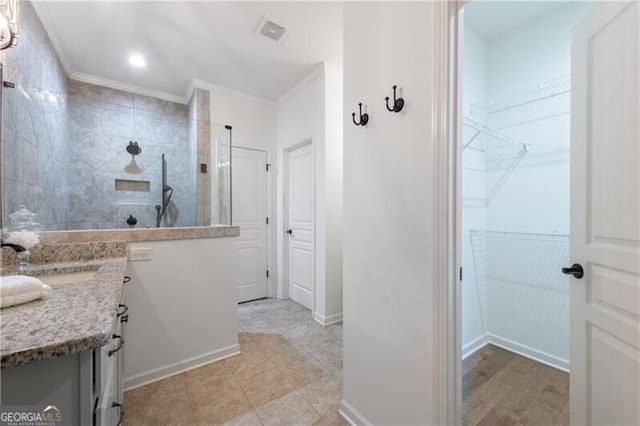 bathroom featuring a shower, vanity, and ornamental molding