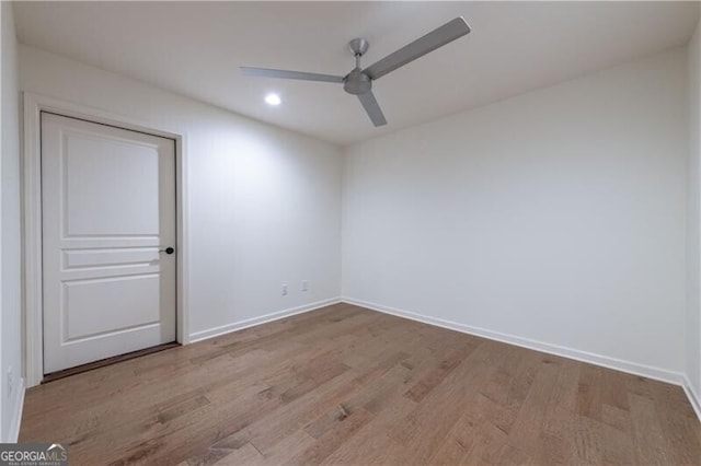 spare room featuring ceiling fan and light hardwood / wood-style flooring