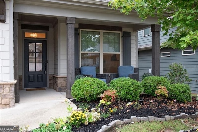 view of exterior entry featuring a porch