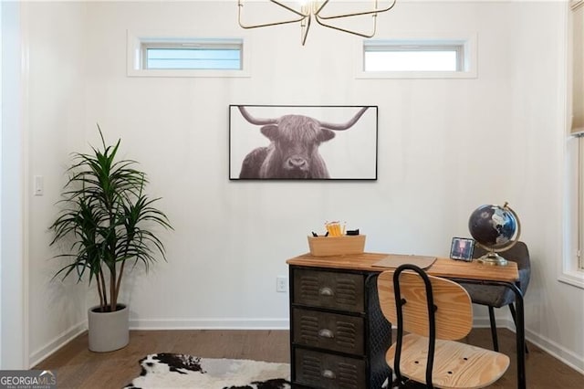 office area with hardwood / wood-style flooring and an inviting chandelier