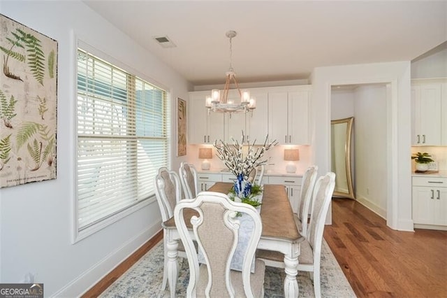 dining room featuring an inviting chandelier and hardwood / wood-style flooring