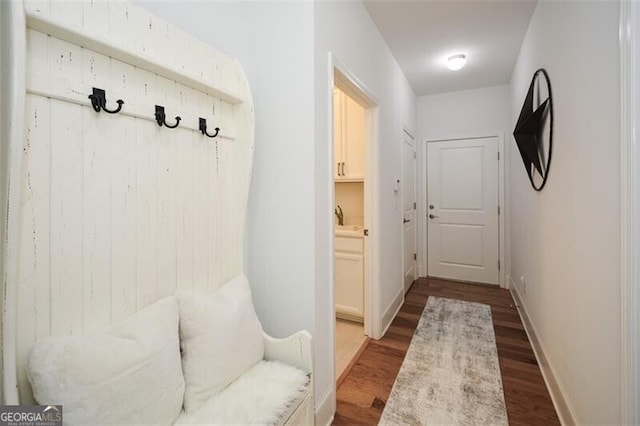 mudroom with hardwood / wood-style flooring and sink