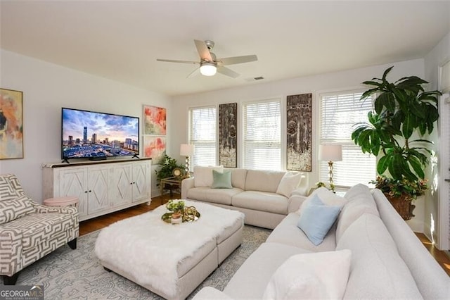 living room featuring a wealth of natural light, ceiling fan, and wood-type flooring