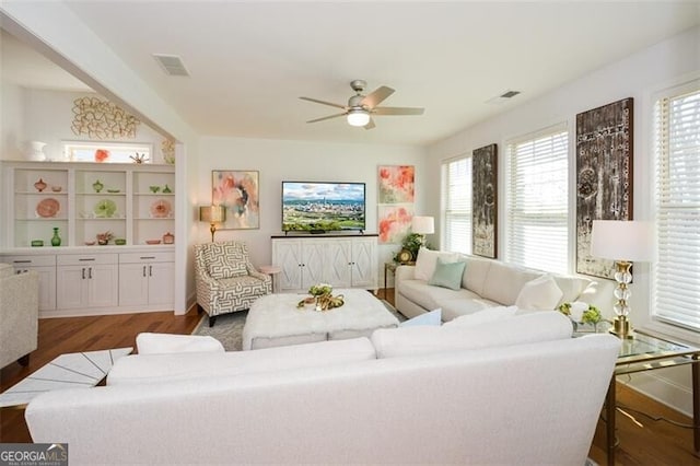 living room featuring dark hardwood / wood-style floors and ceiling fan