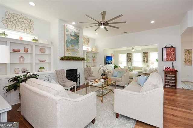 living room with wood-type flooring and ceiling fan