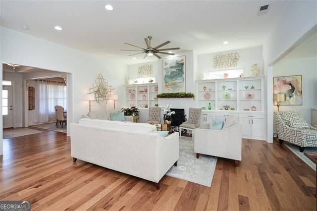 living room with hardwood / wood-style floors and ceiling fan