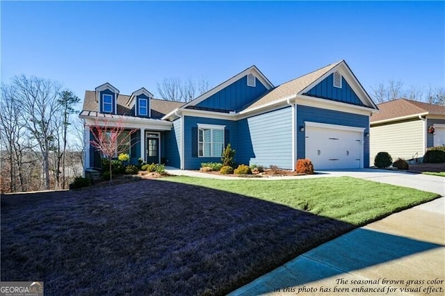 view of front of house featuring a garage and a front lawn