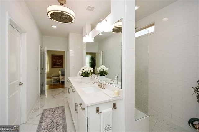 bathroom featuring vanity and a shower