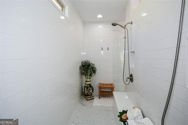 bathroom with a tile shower