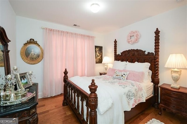 bedroom with hardwood / wood-style floors