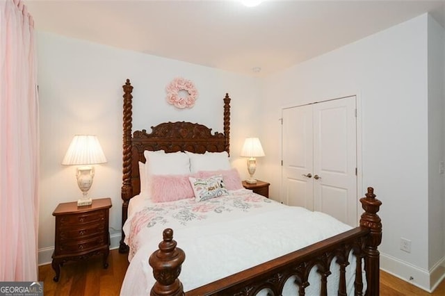 bedroom with a closet and hardwood / wood-style flooring