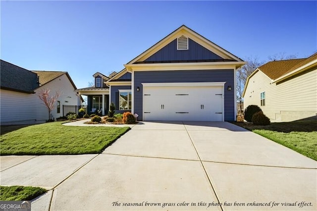 view of front of property with a front lawn and a garage