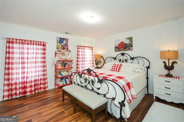 bedroom with dark hardwood / wood-style flooring