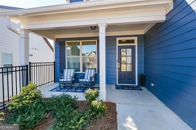 entrance to property featuring covered porch