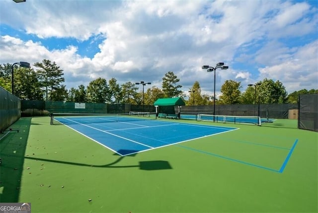 view of sport court with basketball hoop