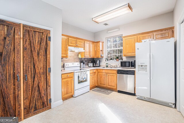 kitchen featuring decorative backsplash, sink, and appliances with stainless steel finishes