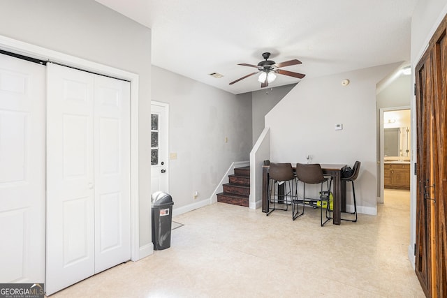 interior space with ceiling fan