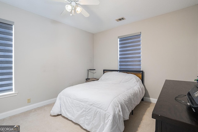 bedroom featuring ceiling fan and light carpet