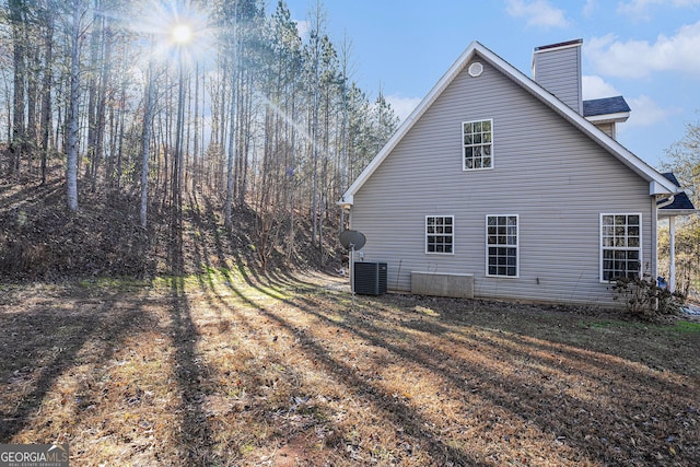 view of side of home with central AC