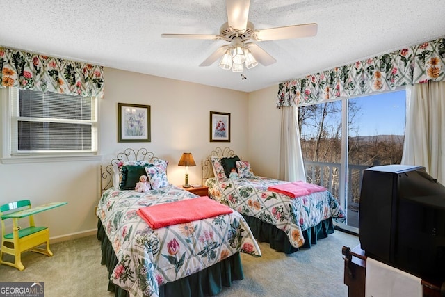 bedroom featuring carpet, ceiling fan, a textured ceiling, and access to outside