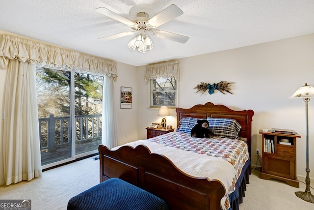 carpeted bedroom with access to outside, ceiling fan, and a textured ceiling