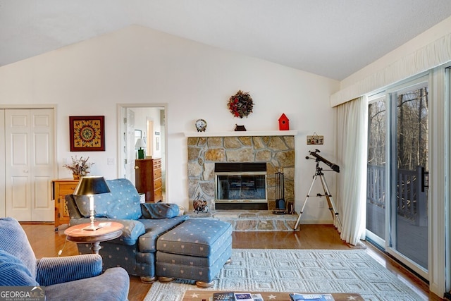 living room with hardwood / wood-style floors, a fireplace, and vaulted ceiling