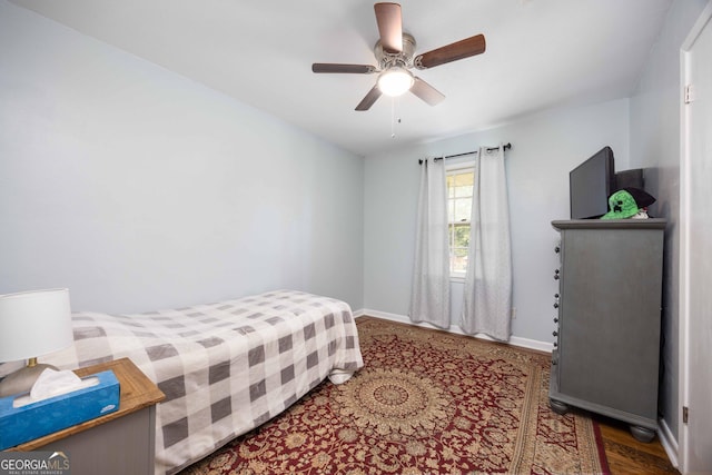 bedroom with ceiling fan and dark wood-type flooring