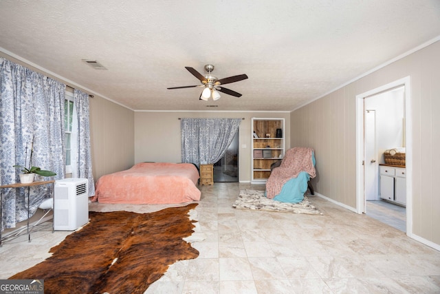 bedroom with ceiling fan, ornamental molding, and a textured ceiling